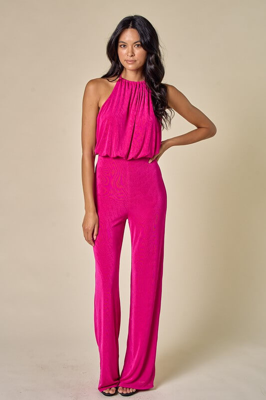 Bridesmaid's Guide to Rehearsal Dinner Hot pink halter neck open back flowy jumpsuit. 