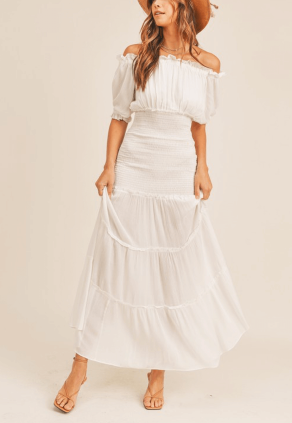 White gauze maxi dress with a fitted waist and a flowy skirt