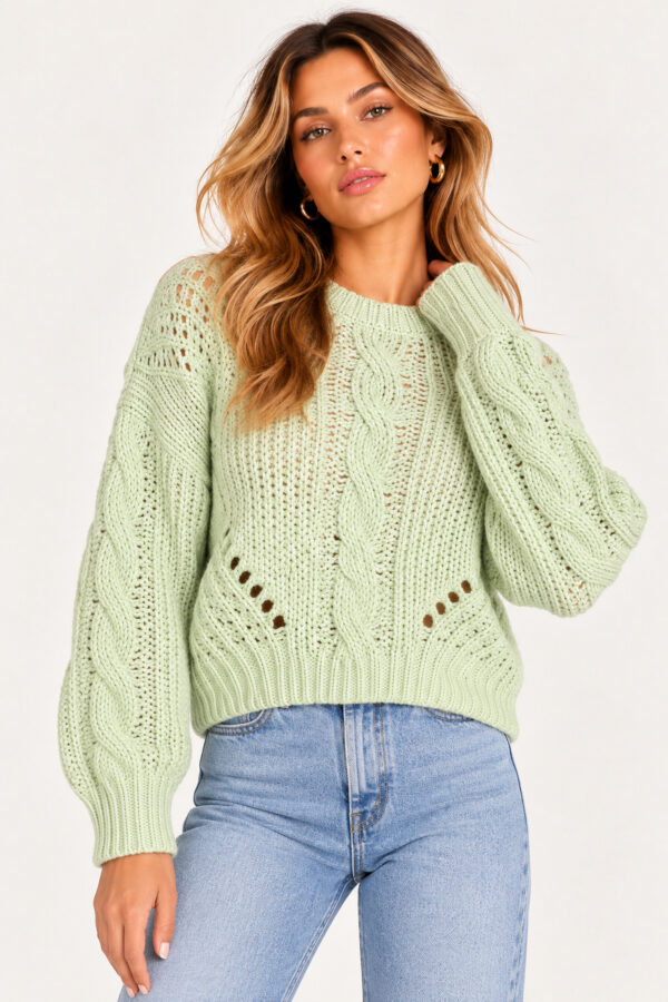 Close-up front view of mint green cable knit sweater featuring textured braided stitching, openwork accents, ribbed hem and long sleeves.