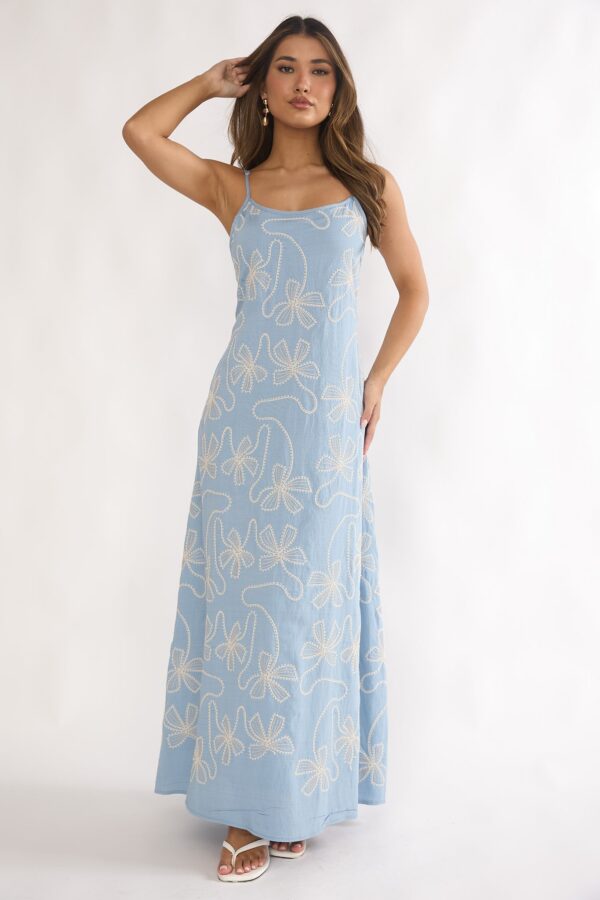 Woman wearing blue embroidered bow maxi dress with spaghetti straps