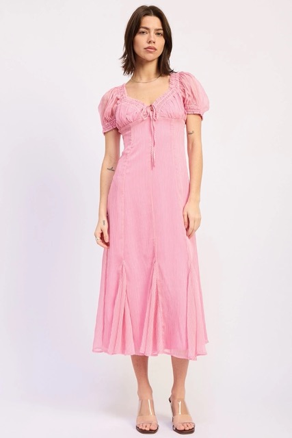 Woman wearing a pink ruffle godet midi dress with puff sleeves for spring and summer