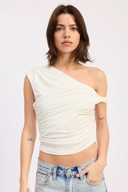 Woman wearing white asymmetrical one shoulder ruched top