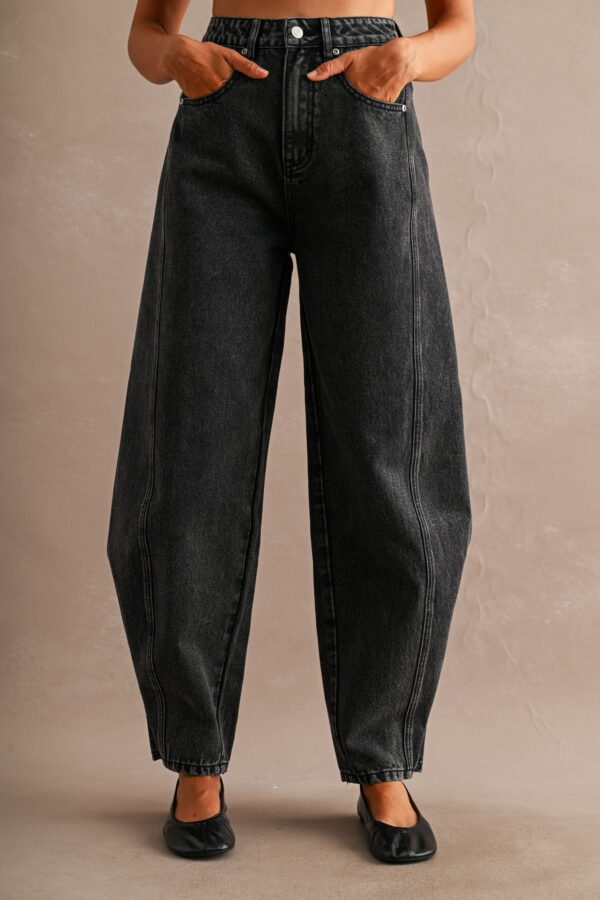 Romy Black Snap Hem Barrel Jeans in black denim shown on a model