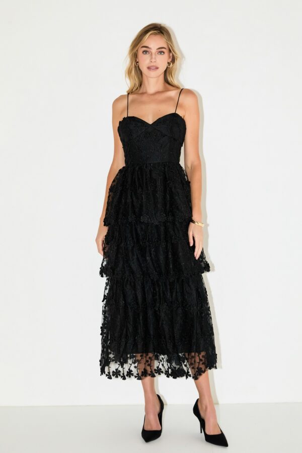Black midi dress with midi-length tiered skirt, sheer crochet lace with lining, thin spaghetti straps styled for women’s occasion fashion