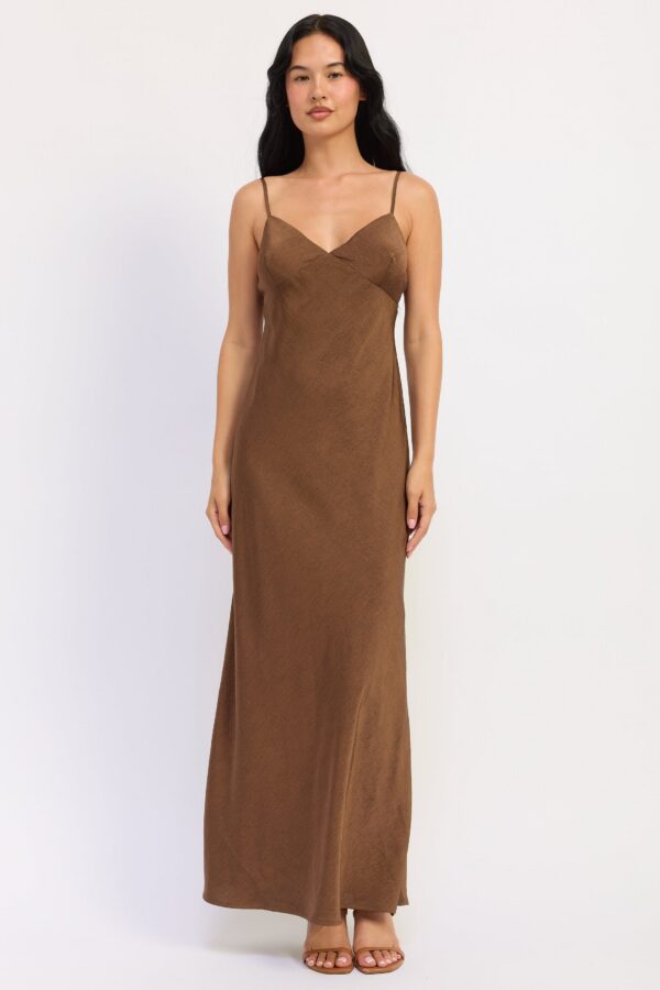 Brown maxi dress with a fluid satin finish and slender spaghetti straps styled for a women’s boutique fashion look