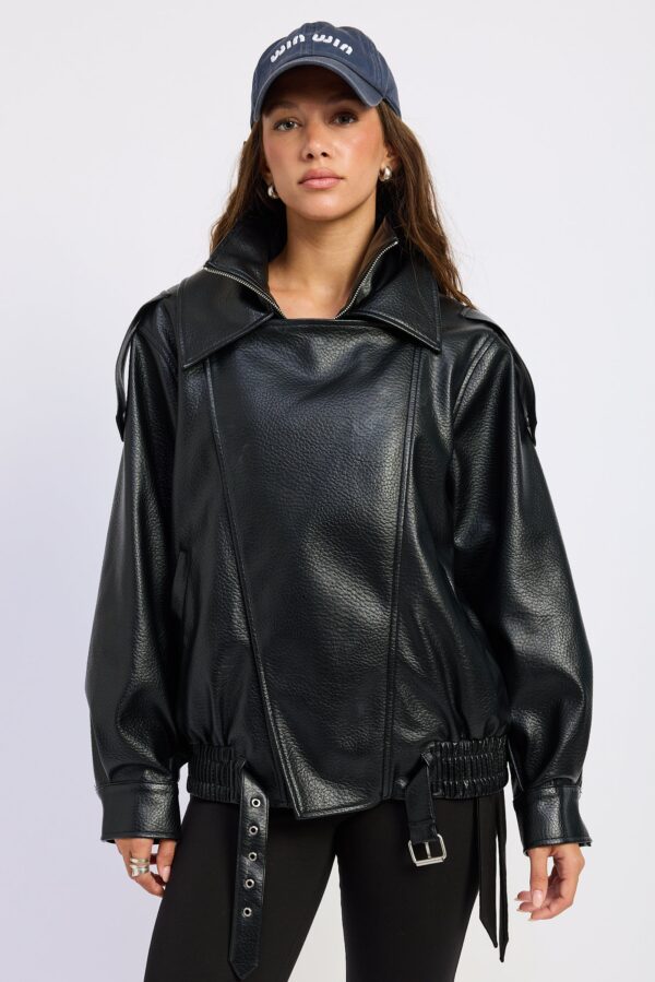 Model wearing black oversized bomber jacket; an oversized silhouette and a double-pointed neckline
