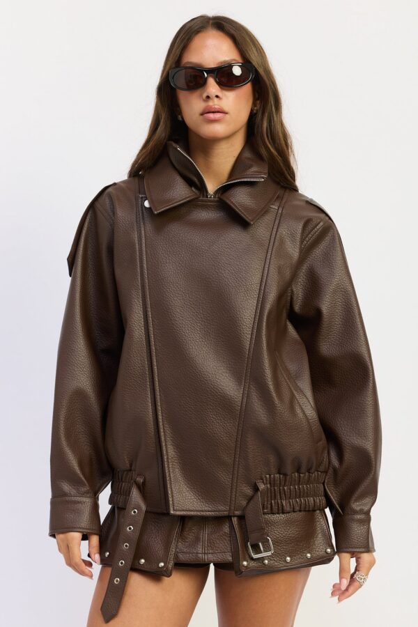Model wearing warm brown oversized bomber jacket; an oversized silhouette and a double-pointed neckline