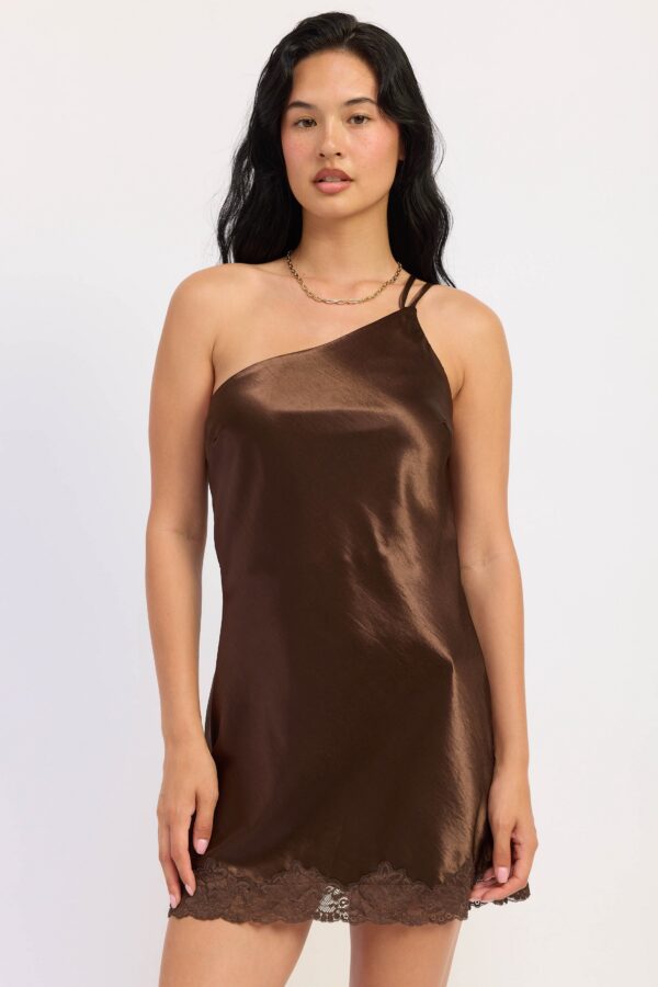 Dark Chocolate mini dress with a satin finish, lace trim, and statement back straps styled for a women’s boutique fashion look