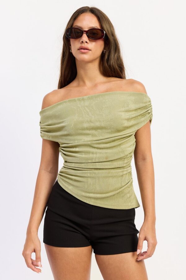 Light Olive top featuring an off-shoulder neckline, asymmetric draping, soft stretch knit, and a sleek body-skimming fit