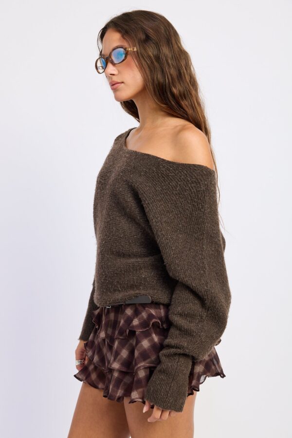 Model wearing espresso brown off shoulder ribbed sweater; an off-shoulder neckline and ribbed sweater texture