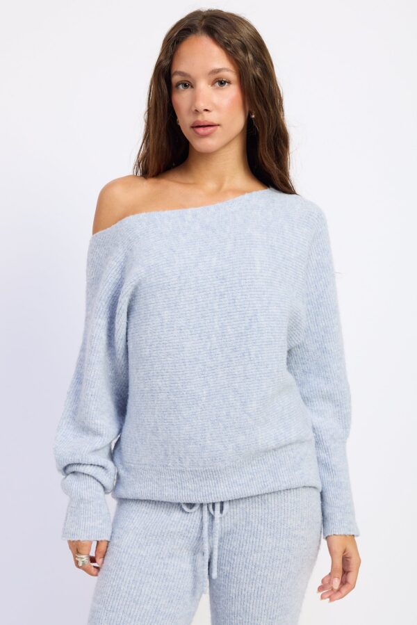 Model wearing powder blue off shoulder ribbed sweater; an off-shoulder neckline and ribbed sweater texture