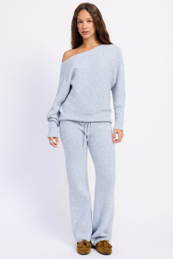 Model wearing powder blue ribbed sweater lounge pants; a ribbed sweater texture and easy lounge-pant shape