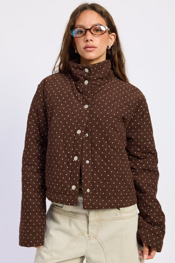 Espresso jacket featuring a quilted puffer shape, playful polka-dot pattern, cozy high neckline, and polished everyday volume