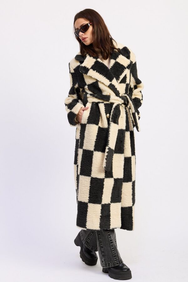 Styled view of ivory black checkerboard belted faux fur coat