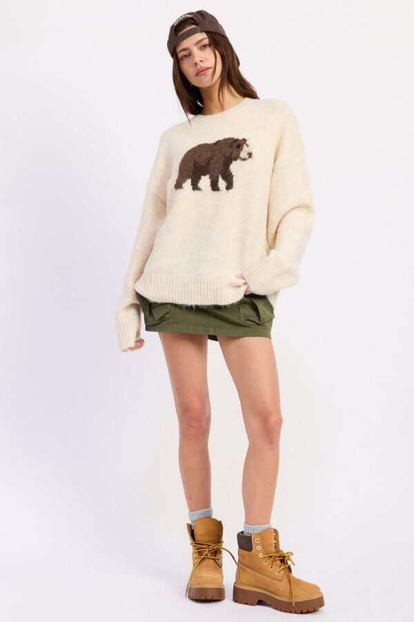 Styled view of cream grizzly bear graphic knit sweater